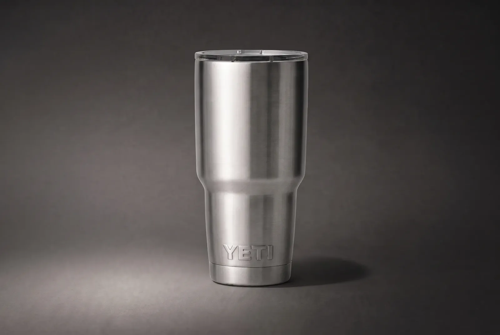 A stainless tumbler photographed to make its lid, rim, brushed finish, taper, and base easy to inspect.