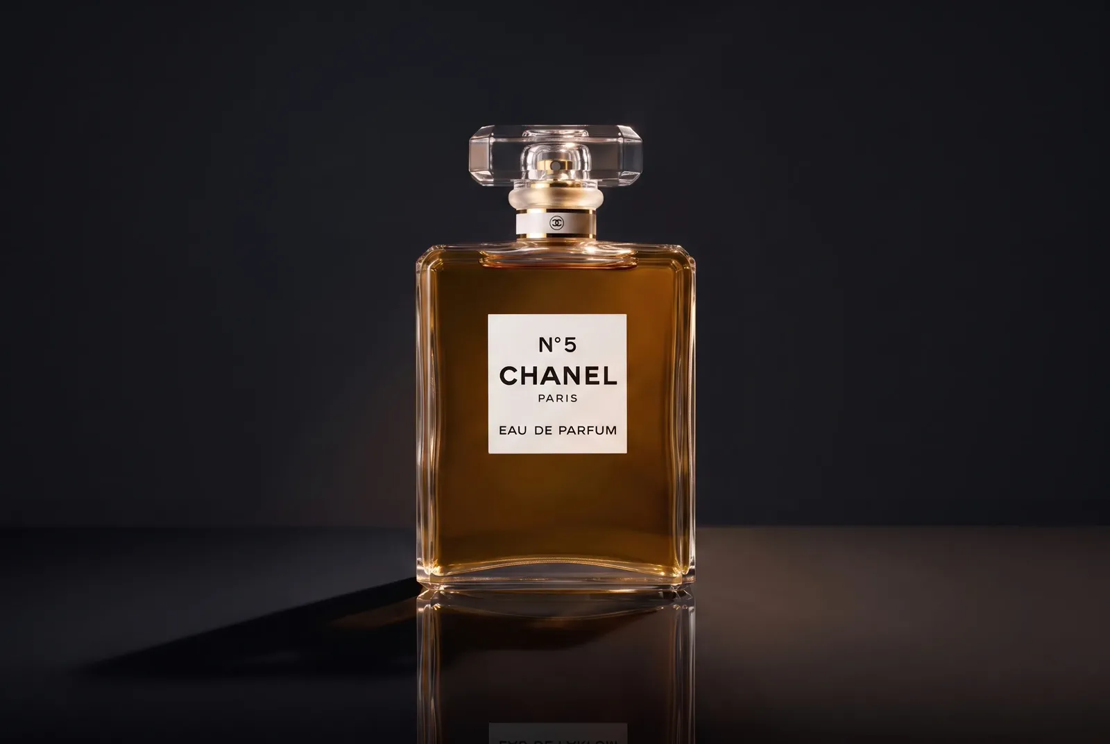 A rectangular amber fragrance bottle shaped by warm edge light against a dark field.