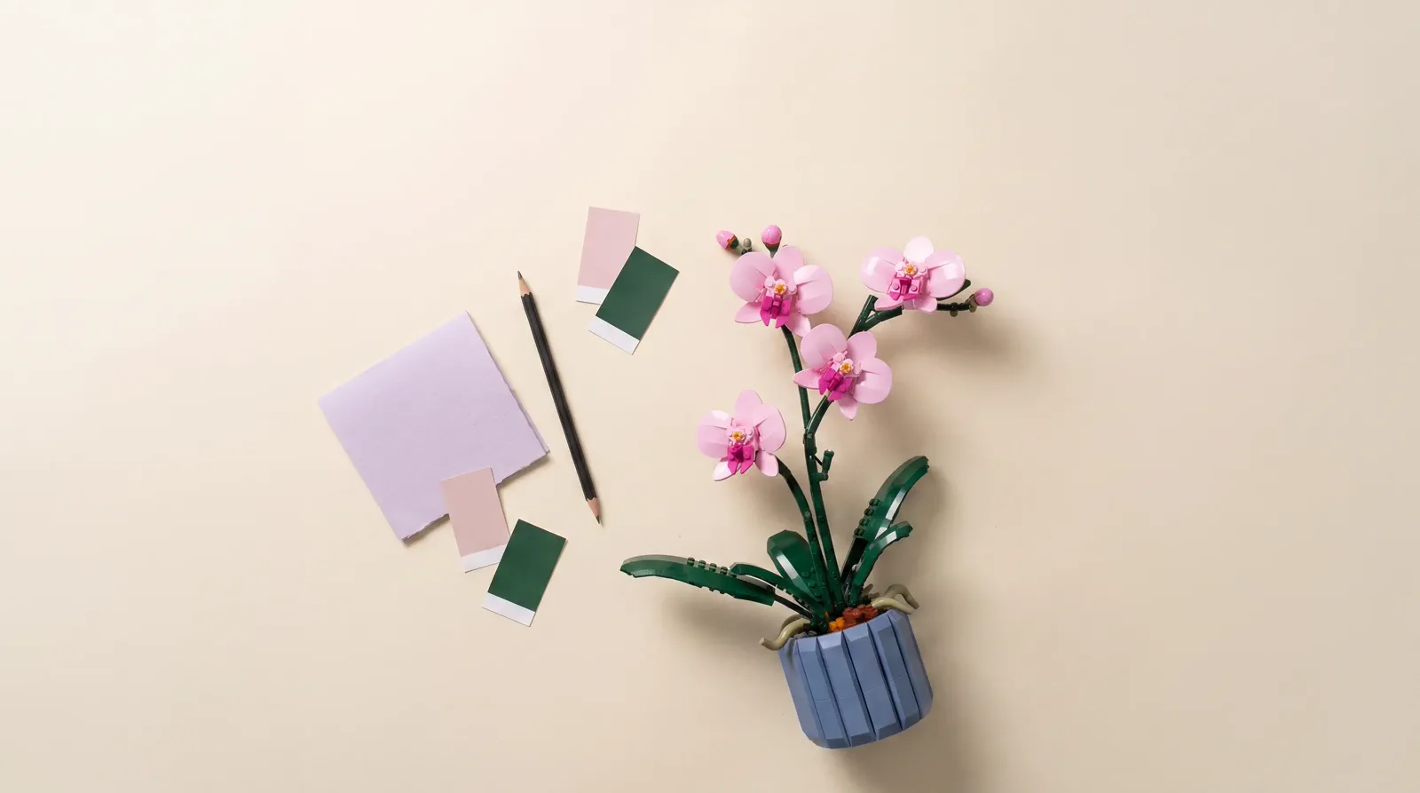 A top-down creative-home arrangement with a botanical model as the lead object and open space for copy.