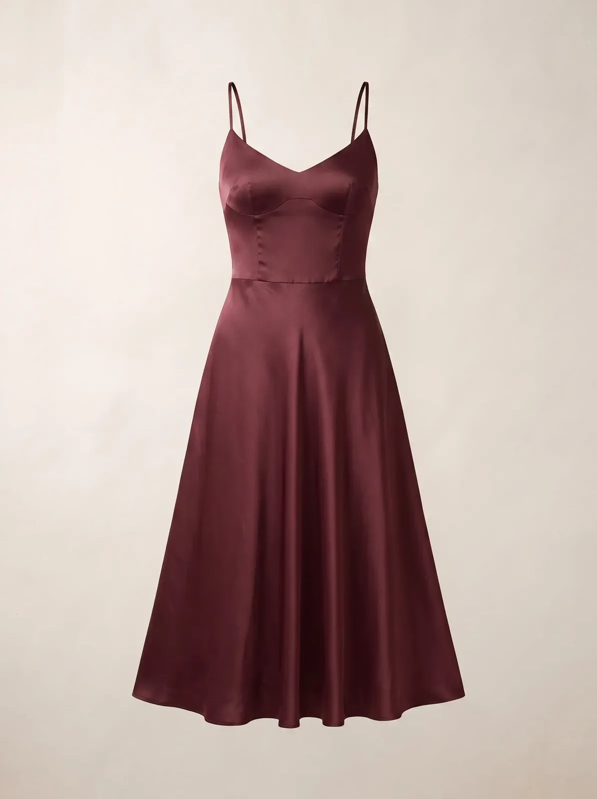 A women’s satin midi dress shown without a visible person while its straps, neckline, waist, fluid drape, and complete hem remain coherent.