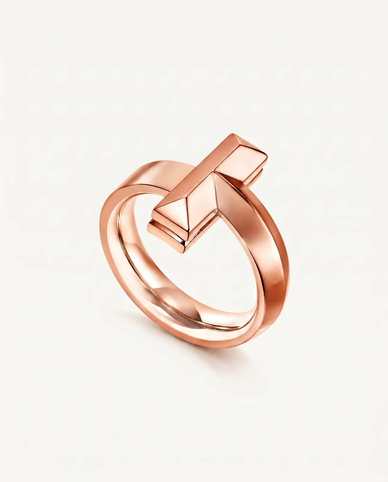 A rose-gold sculptural ring photographed as a clear source product.